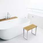 Invisia Shower Bench beside a beautiful freestanding bathtub
