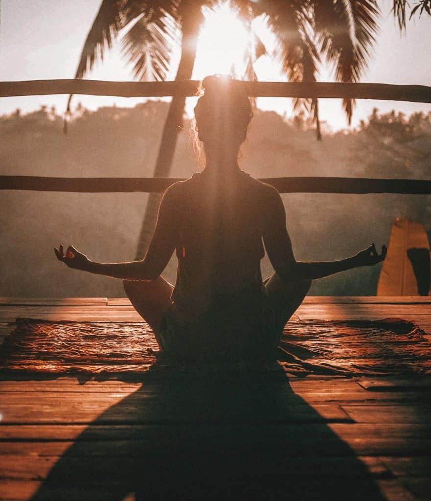 Woman doing yoga in a tropical area