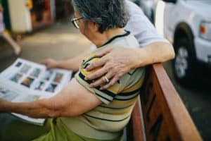 elderly couple sitting on a bench